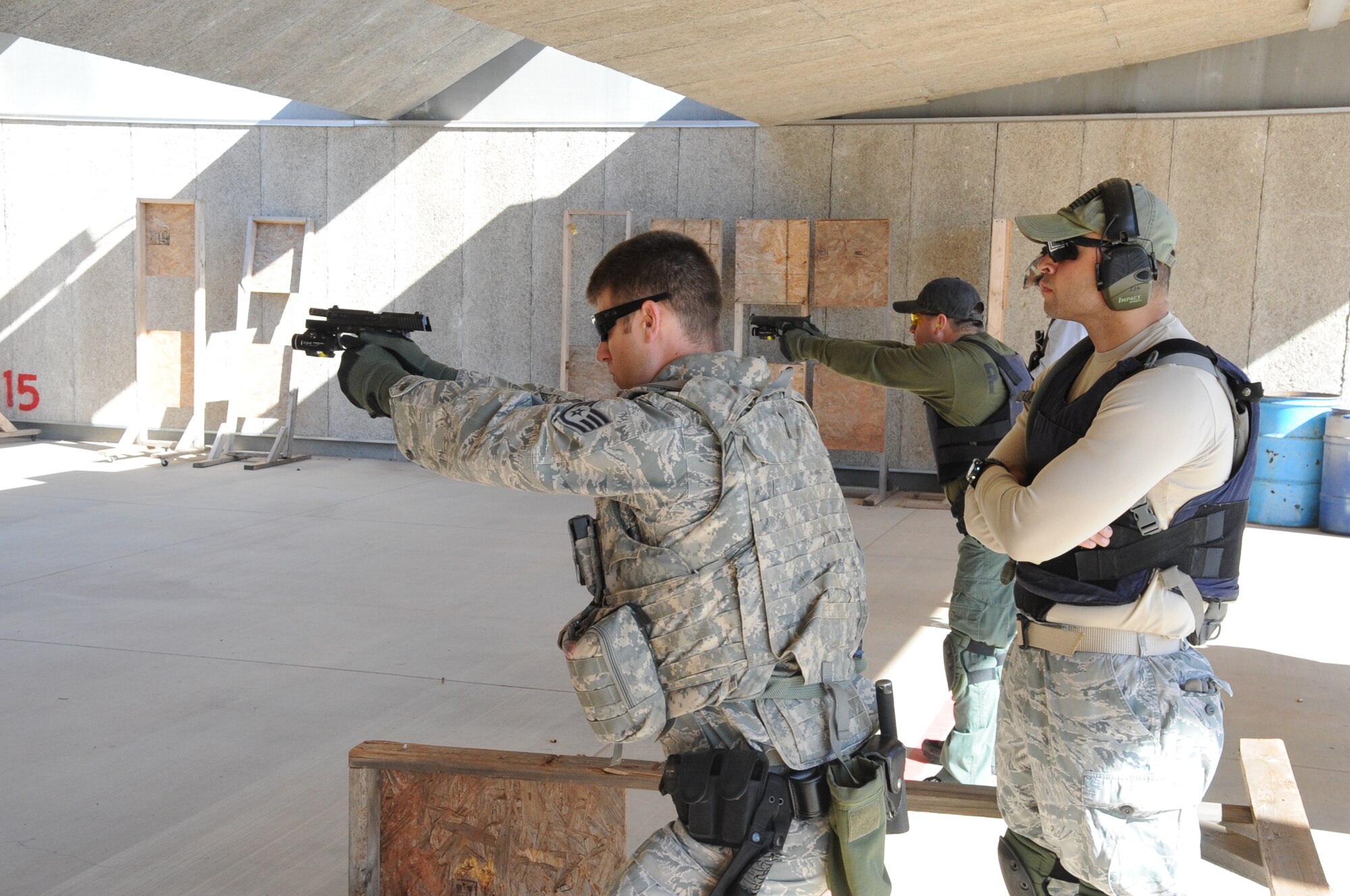 Staff Sgt. Paul Brow does a pistol drill at a law enforcement shooting range March 14, 2013. The exercise was a part of a joint exercise with an Air Force Explosive Ordinance Disposal team from the 366th Training Squadron. (U.S. Air Force photo by Airman 1st Class Jelani Gibson)