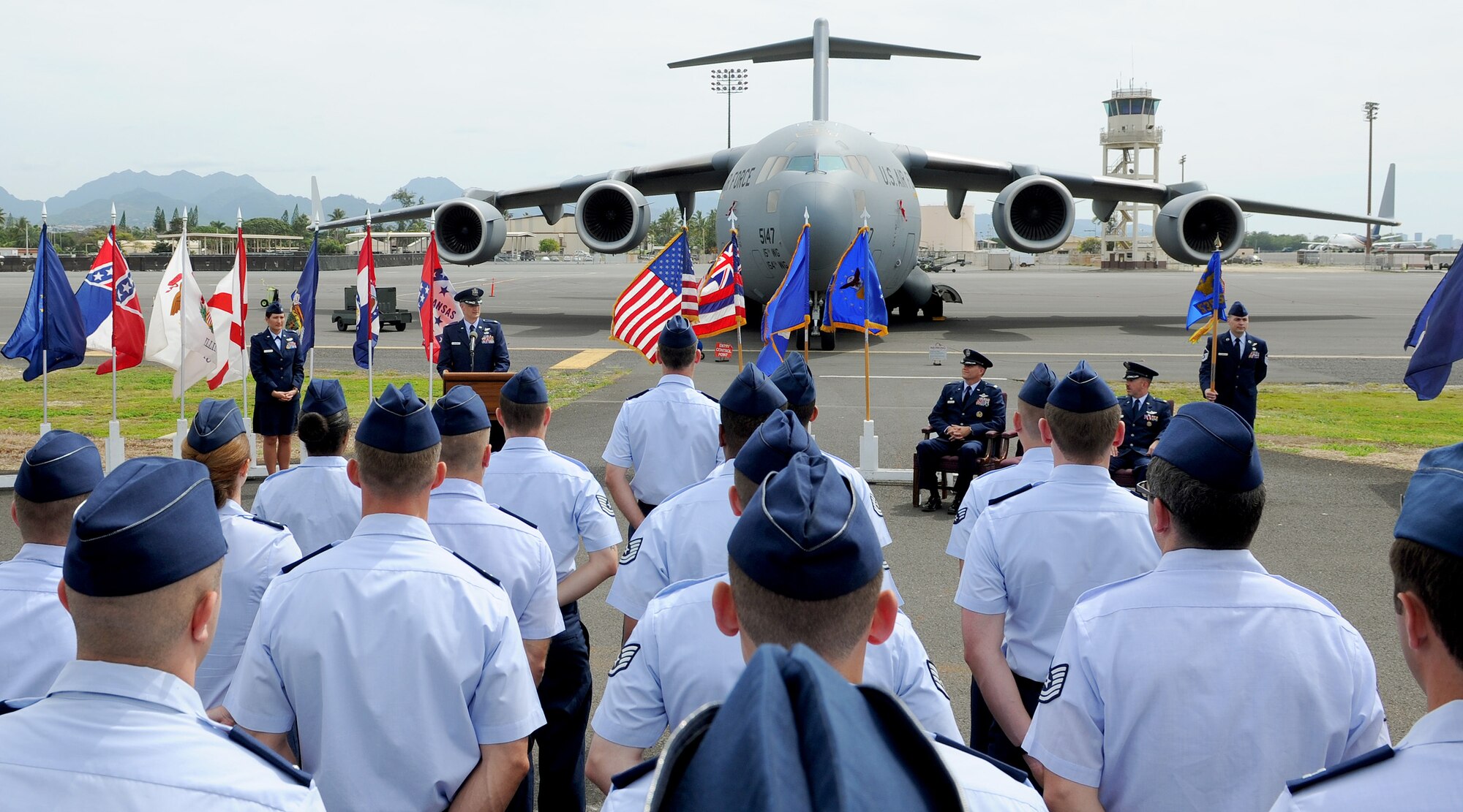 Members of the 535th Airlift Squadron stand in formation during the 535th AS change of command ceremony near the flightline at Joint Base Pearl Harbor-Hickam, Hawaii. Hundreds gathered as Lt. Col. Gregg S. Johnson assumed command of the 535th AS from Lt. Col. Patrick C. Winstead. (U.S. Air Force photo/Tech. Sgt. Jerome S. Tayborn)