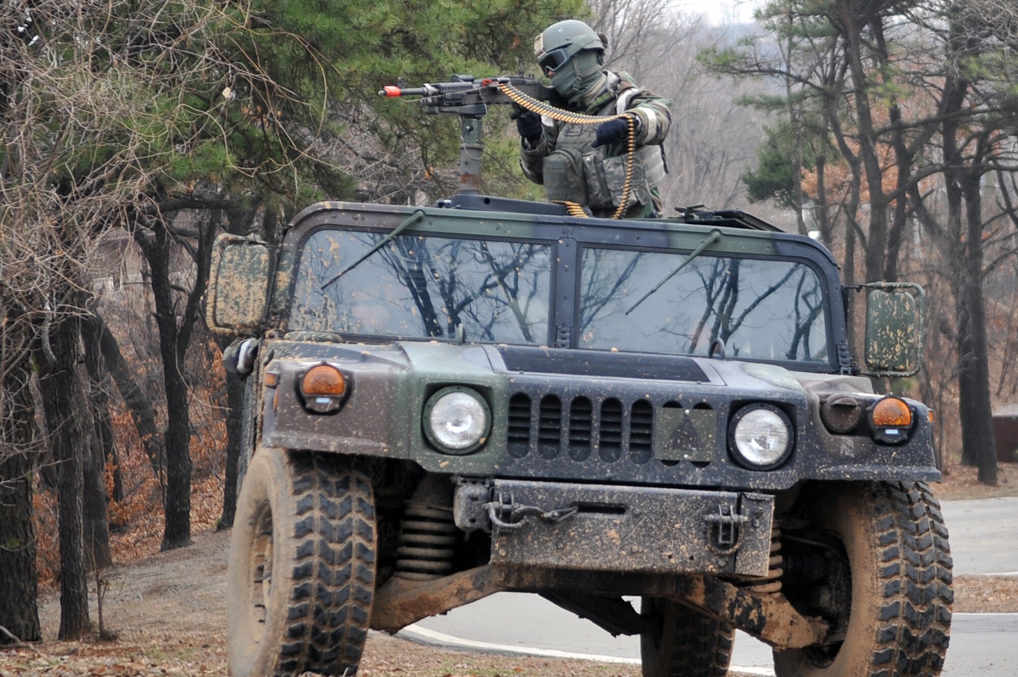 Airman 1st Class Adrian Davis, 51st Security Forces defender, takes aim as a gunner while patrolling and defending the base during  Operational Readiness Exercise Beverly Midnight 13-02 at Osan Air Base, Republic of Korea, March 19, 2013.  Osan participates in these exercises so Airmen can demonstrate their capabilities and ability to perform in heightened awareness situations. The 51st SFS plays a variety of roles that contribute to the overall safety and security of the base in both real world and contingency situations. (U.S. Air Force photo/Senior Airman Alexis Siekert) 