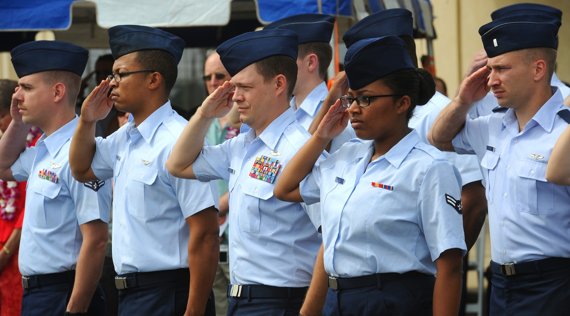 Members of the 535th Airlift Squadron salute during the singing of the national anthem at the 535th AS change of command ceremony, near the flightline at Joint Base Pearl Harbor-Hickam, Hawaii, March 15, 2013.  The 535th is assigned to the 15th Operations Group which is responsible to the 15th wing commander for all airlift operations with the Eastern Pacific. (U.S. Air Force photo/Tech. Sgt. Jerome S. Tayborn)