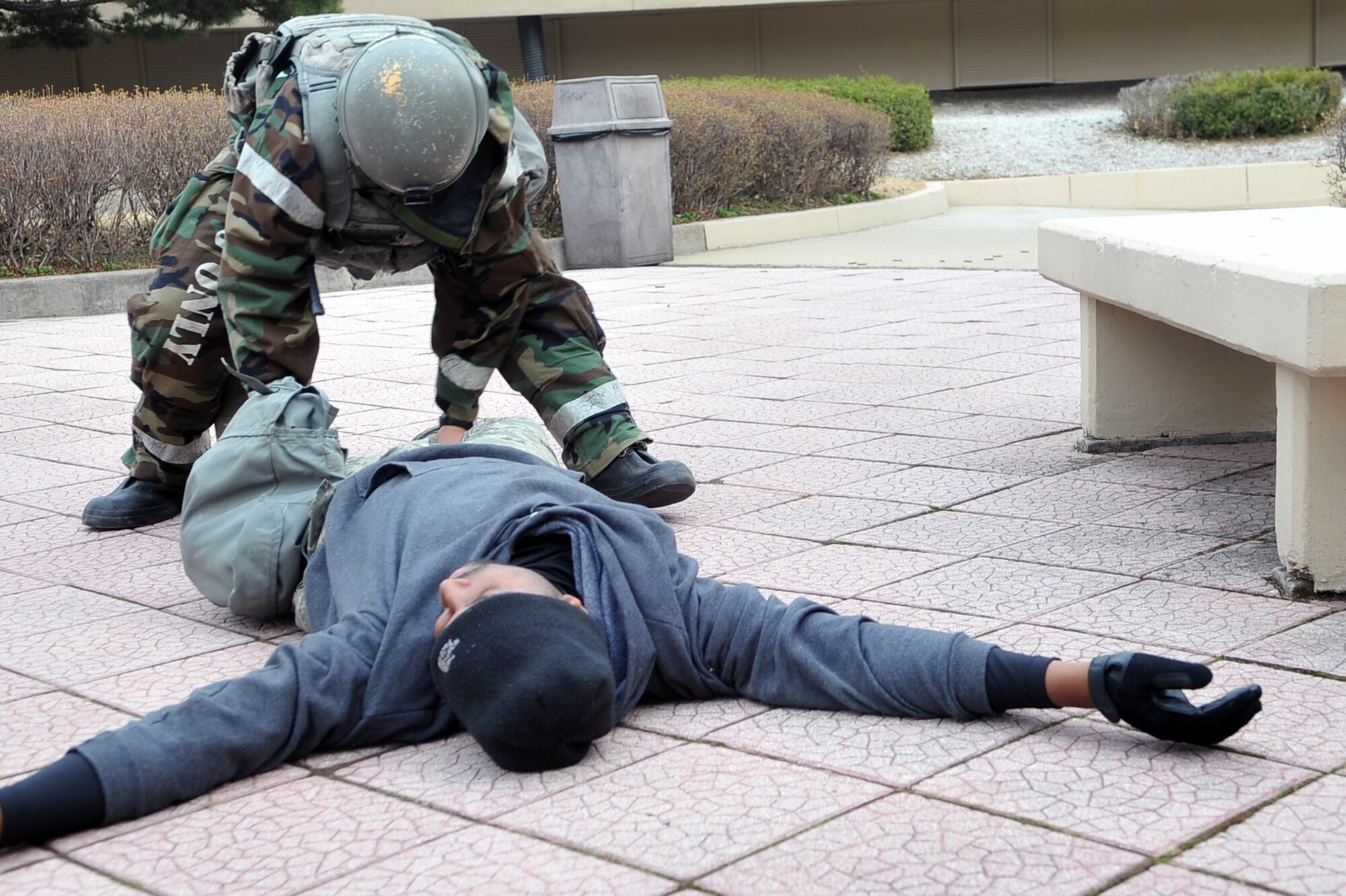 Senior Airman Sean Everage, 51st Security Forces defender, checks the body of an enemy combatant as part of a training scenario during an Operational Readiness Exercise Beverly Midnight 13-02 at Osan Air Base, Republic of Korea, March 19, 2013. The training scenario tested the 51st SFS’s ability to defend the base against opposing forces in a heightened state of readiness. This is Osan’s third simulated wartime contingency exercise in 2013. (U.S. Air Force photo/Senior Airman Alexis Siekert) 