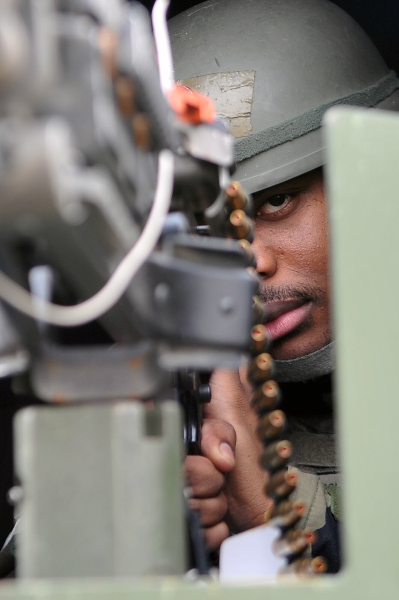 Senior Airman Chris Coleman, 51st Security Forces defender, takes aim as a gunner inside his truck during a training scenario to defend the base at Osan Air Base, Republic of Korea, March 19, 2013.  The training scenario was one of many during Operational Readiness Exercise Beverly Midnight 13-02, that help Airmen sharpen their skills in case of a real world contingency. (U.S. Air Force photo/Senior Airman Alexis Siekert) 