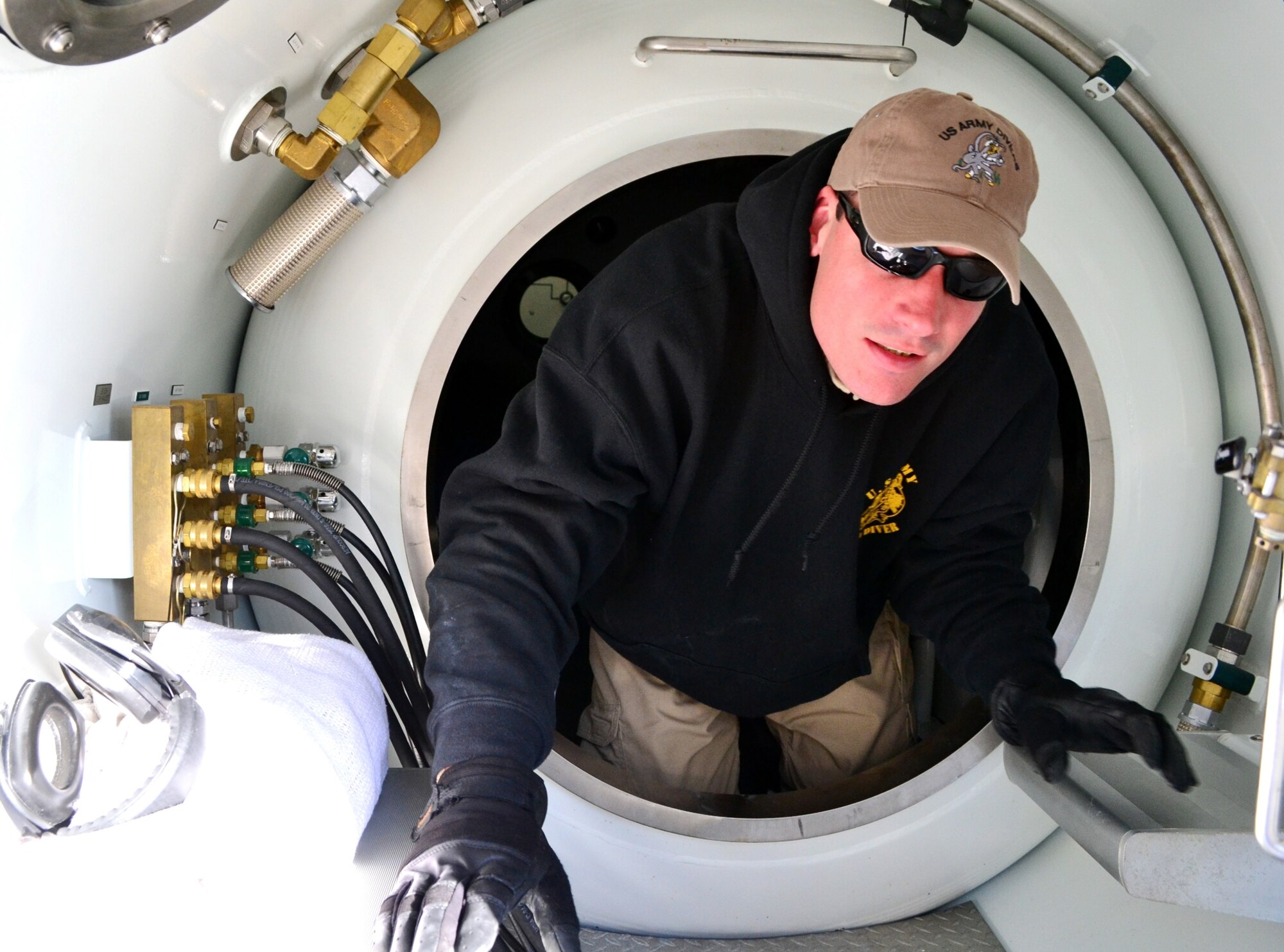 U.S. Army Spc. Thomas Dougherty, assigned to the 511th Dive Detachment, Special Troops Battalion, 7th Sustainment Brigade, inspects the stability of a decompression chamber aboard the Landing Craft Utility 2004 before the start of a training exercise off the Cheatham Annex Naval Station, Va. shore March 6, 2013. The team was evaluated on how successfully they could operate when normal dive operations go awry.  (U.S. Army photo by Sgt. Edwin Rodriguez/Released)