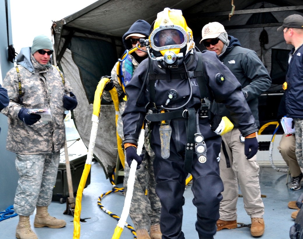 U.S. Army Spc. Jacob Feyers, center, assigned to the 511th Dive Detachment, Special Troops Battalion, 7th Sustainment Brigade, begins his walk to the end of the ramp while aboard the Landing Craft Utility 2004 during a training exercise off the Cheatham Annex Naval Station, Va. shore March 6, 2013. The team was evaluated on how successfully they could operate when normal dive operations go awry.  (U.S. Army photo by Sgt. Edwin Rodriguez/Released)