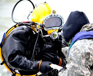 U.S. Army Spc. Jacob Feyers, assigned to the 511th Dive Detachment, Special Troops Battalion, 7th Sustainment Brigade, is pulled aboard the Landing Craft Utility 2004 by his line tenders during a training exercise off the Cheatham Annex Naval Station, Va. shore Mar. 6, 2013. The team was evaluated on how successfully they could operate when normal dive operations go awry. (U.S. Army photo by Sgt. Edwin Rodriguez/Released)