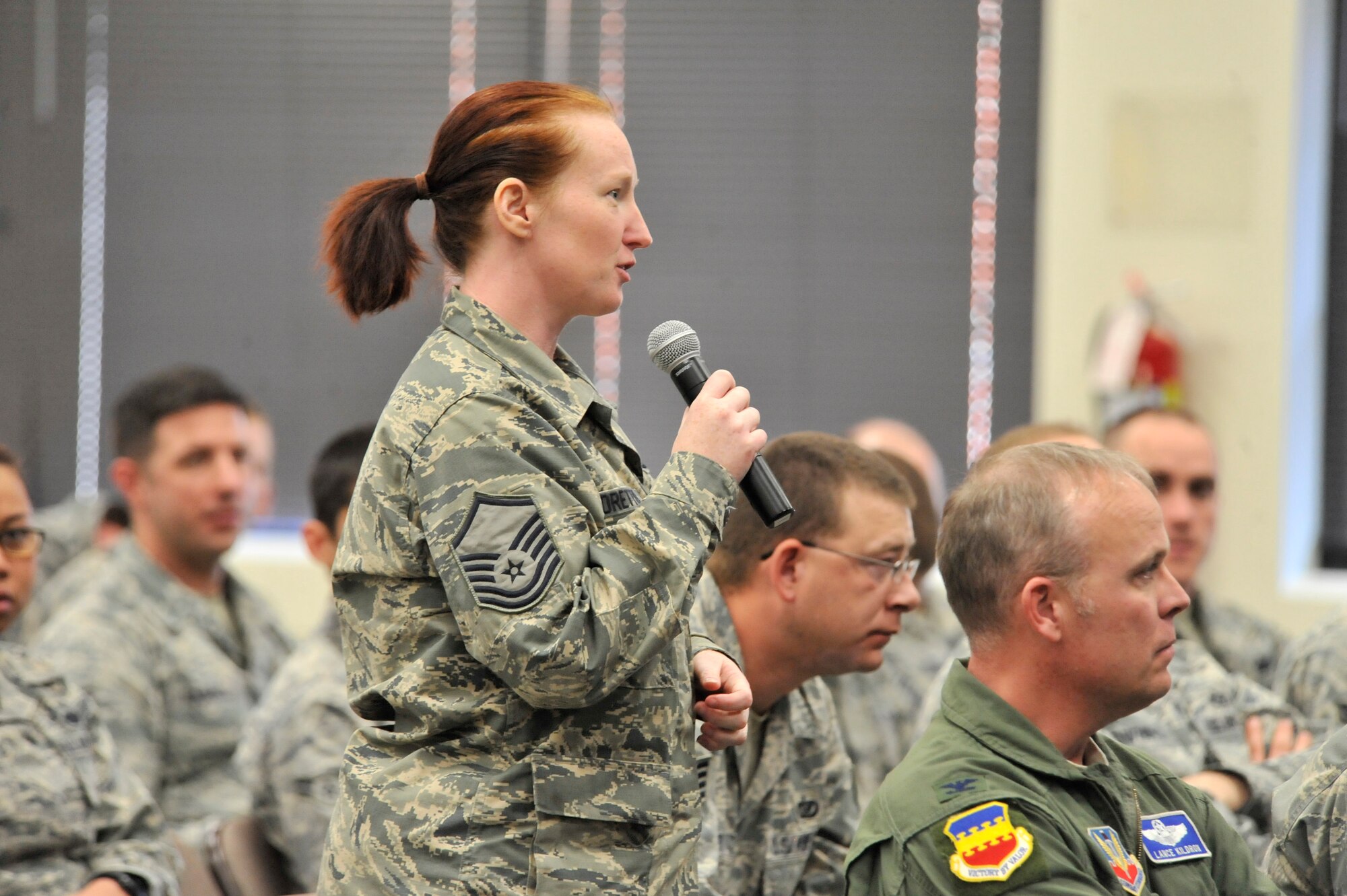 U.S. Air Force Master Sgt. Julie Moretto, Team Shaw Top 3 treasurer, asks a question during the first-ever Leadership Friday, Shaw Air Force Base Community Activity Center, S.C., March 15, 2013. Presented by the Team Shaw Top 3, the event was part of a new effort called “Leadership Friday.” A guest speaker will talk to Team Shaw about leading every quarter. Sumter Mayor Joseph McElveen, Jr., a former Air Force officer, was the first guest speaker to share from his experiences as a leader. (U.S. Air Force photo by Senior Airman Amber E. N. Jacobs/Released)