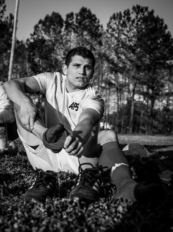 Richard Babb, 437th Aerial Port Squadron intramural soccer team defender, removes his socks and cleats after losing to the 437th Aircraft Maintenance Squadron intramural soccer team March 14, 2013, at the Joint Base Charleston – Air Base soccer fields. The 437th AMXS soccer team squeaked by the 437th APS soccer team in a 4 – 2 shootout win in Joint Base Charleston’s 2013 intramural soccer season opener. (U.S. Air Force photo/ Senior Airman Dennis Sloan) 