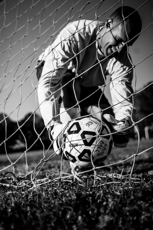 Austin Johnson, 437th Aerial Port Squadron intramural soccer team goalie, grabs the game ball from the back of the net after a member of the 437th Aircraft Maintenance Squadron intramural soccer team scored March 14, 2013, at the Joint Base Charleston – Air Base soccer fields. The 437th AMXS soccer team squeaked by the 437th APS soccer team in a 4 – 2 shootout win in Joint Base Charleston’s 2013 intramural soccer season opener. (U.S. Air Force photo/ Senior Airman Dennis Sloan) (U.S. Air Force photo/ Senior Airman Dennis Sloan)