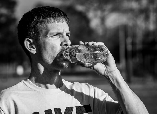 Dasan Bevil, 437th Aerial Port Squadron intramural soccer team defender, hydrates on the side line at halftime during the game against the 437th Aircraft Maintenance Squadron intramural soccer team March 14, 2013, at the Joint Base Charleston – Air Base soccer fields. The 437th AMXS soccer team squeaked by the 437th APS soccer team in a 4 – 2 shootout win in Joint Base Charleston’s 2013 intramural soccer season opener. (U.S. Air Force photo/ Senior Airman Dennis Sloan)