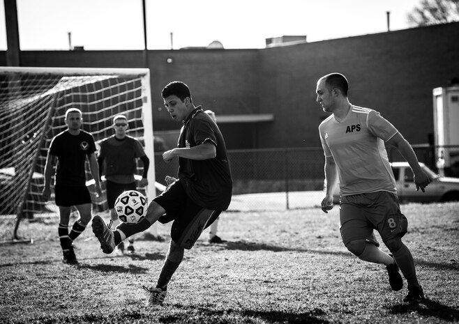 Mohammed Rezk, 437th Aircraft Maintenance Squadron intramural soccer team forward, settles the ball as a member of the 437th Aerial Port Squadron intramural soccer team pursues him March 14, 2013, at the Joint Base Charleston – Air Base soccer fields. The 437th AMXS soccer team squeaked by the 437th APS soccer team in a 4 – 2 shootout win in Joint Base Charleston’s 2013 intramural soccer season opener. (U.S. Air Force photo/ Senior Airman Dennis Sloan)