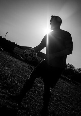Andrew Gravett, 437th Aircraft Maintenance Squadron intramural soccer team coach, places the ball at mid-field for the start of the game against the 437th Aerial Port Squadron intramural soccer team March 14, 2013, at the Joint Base Charleston – Air Base soccer fields. The 437th AMXS soccer team squeaked by the 437th APS soccer team in a 4 – 2 shootout win in Joint Base Charleston’s 2013 intramural soccer season opener. (U.S. Air Force photo/ Senior Airman Dennis Sloan)