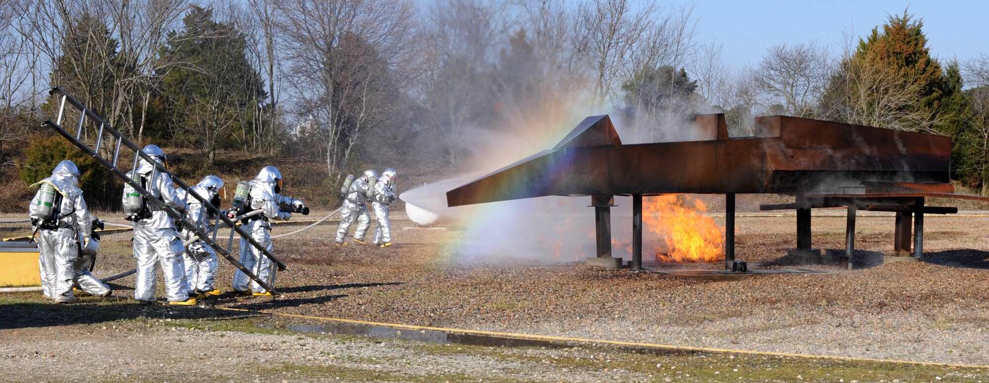 633rd Civil Engineering Squadron firefighters contain a fire during a live-fire exercise at Langley Air Force Base, Va., Feb. 28, 2013. Live-fire exercises are used to train firefighters so if an aircraft were to catch fire, they can contain the fire seamlessly and keep people safe. (U.S. Air Force photo by Senior Airman Brittany Paerschke-O’Brien/Released)