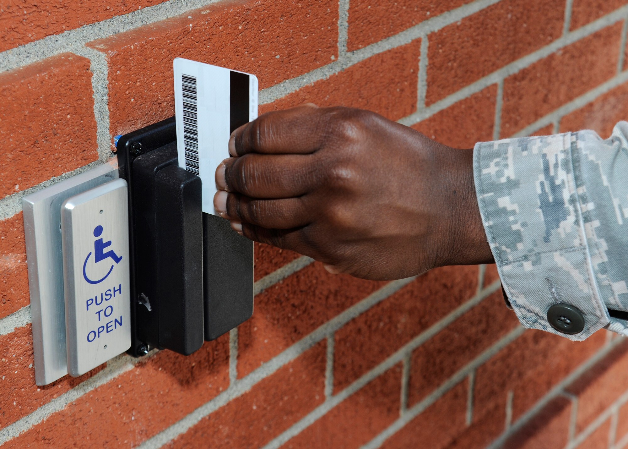An Airman scans his common access card to access the fitness center after hours at Fairchild Air Force Base, Wash., March 18, 2013. The fitness center now offers 24-hour access to those who pre-register their CAC during normal work hours. (U.S. Air Force photo by Airman 1st Class Ryan Zeski)