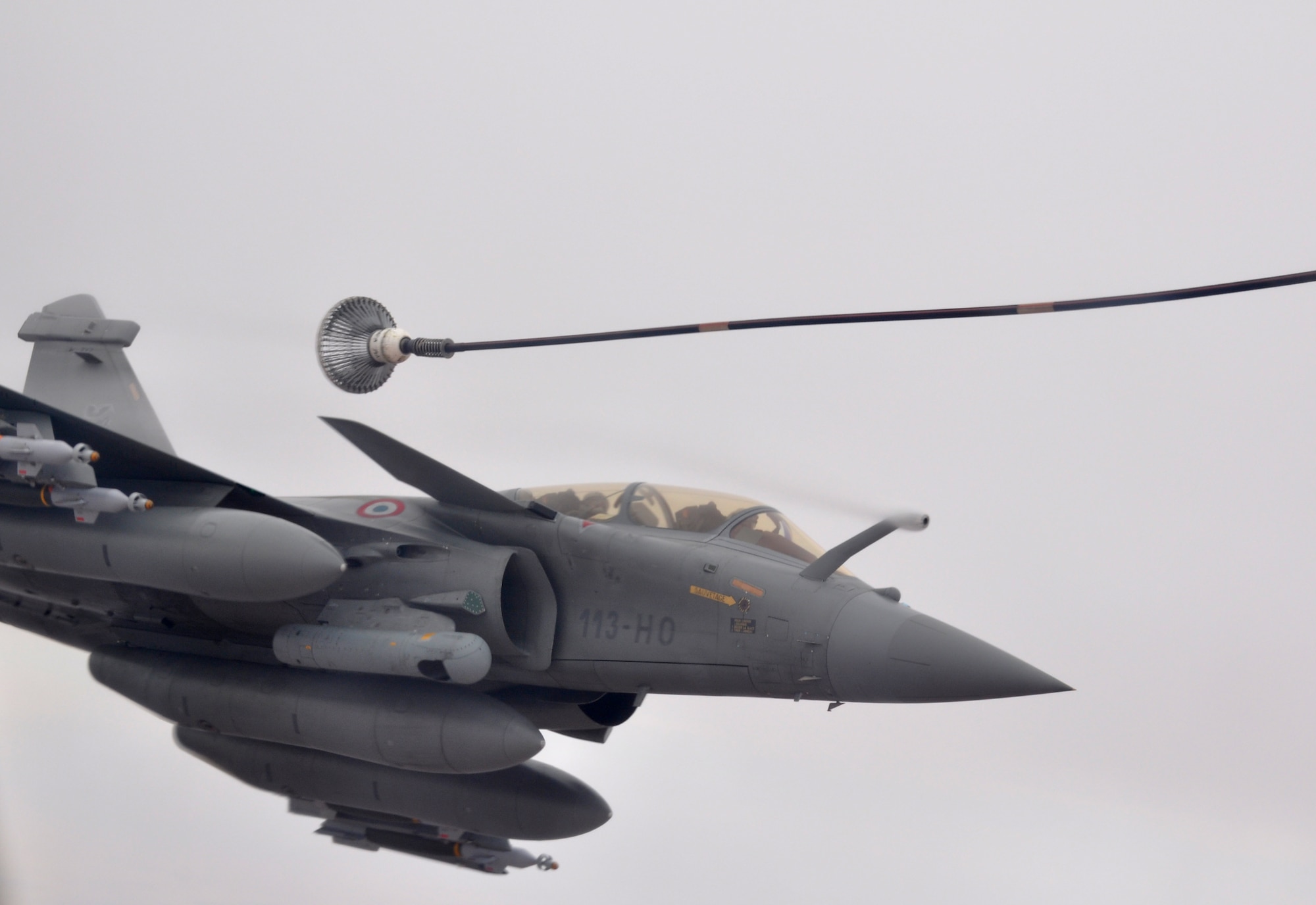 A French fighter aircraft rolls left away from a KC-135 Stratotanker flown by the 351st Expeditionary Air Refueling Squadron during a March 17, 2013, mission. (U.S. Air Force photo by Capt. Jason Smith)