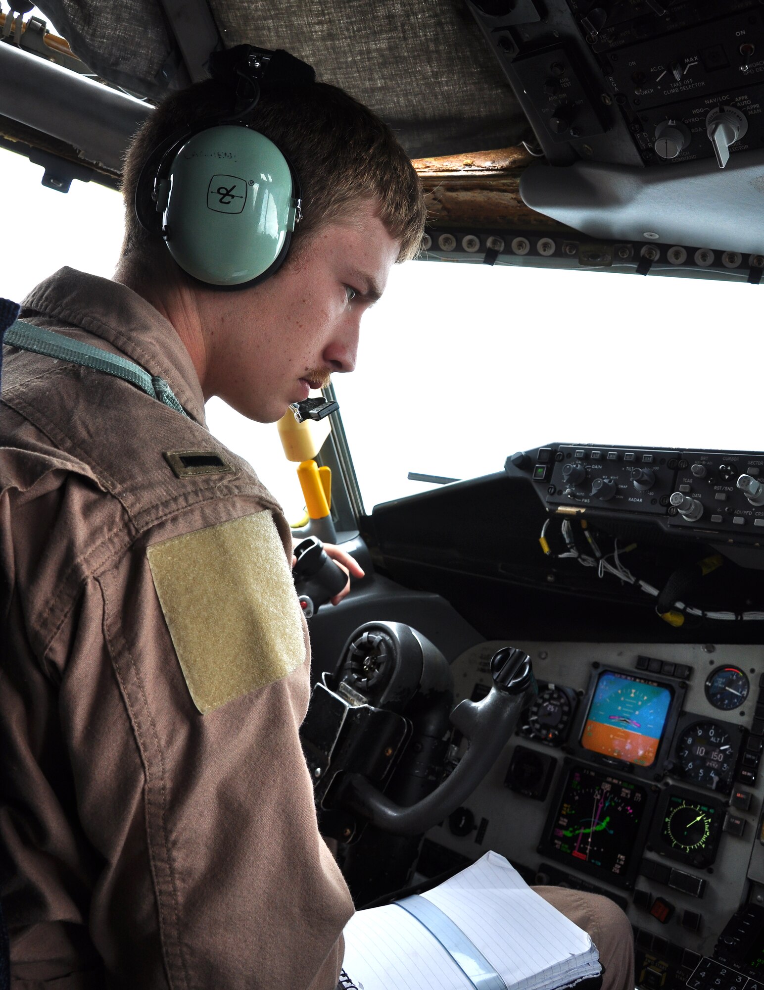 First Lt. John Lachiewicz, 351st Expeditionary Air Refueling Squadron, performs an after-climb check on a KC-135 Stratotanker shortly after takeoff on a March 17, 2013, mission. (U.S. Air Force photo by Capt. Jason Smith)