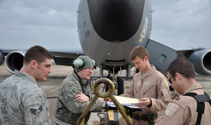 (Left to right) Senior Airman Michael Warren and Tech. Sgt. Michael Mackey, both 100th Aircraft Maintenance Squadron, review maintenance logs and the flight plan with 1st Lt. John Lachiewicz and Capt. Tim Gerne, both 351st Expeditionary Air Refueling Squadron, prior to their flight on March 17, 2013. (U.S. Air Force photo by Capt. Jason Smith)