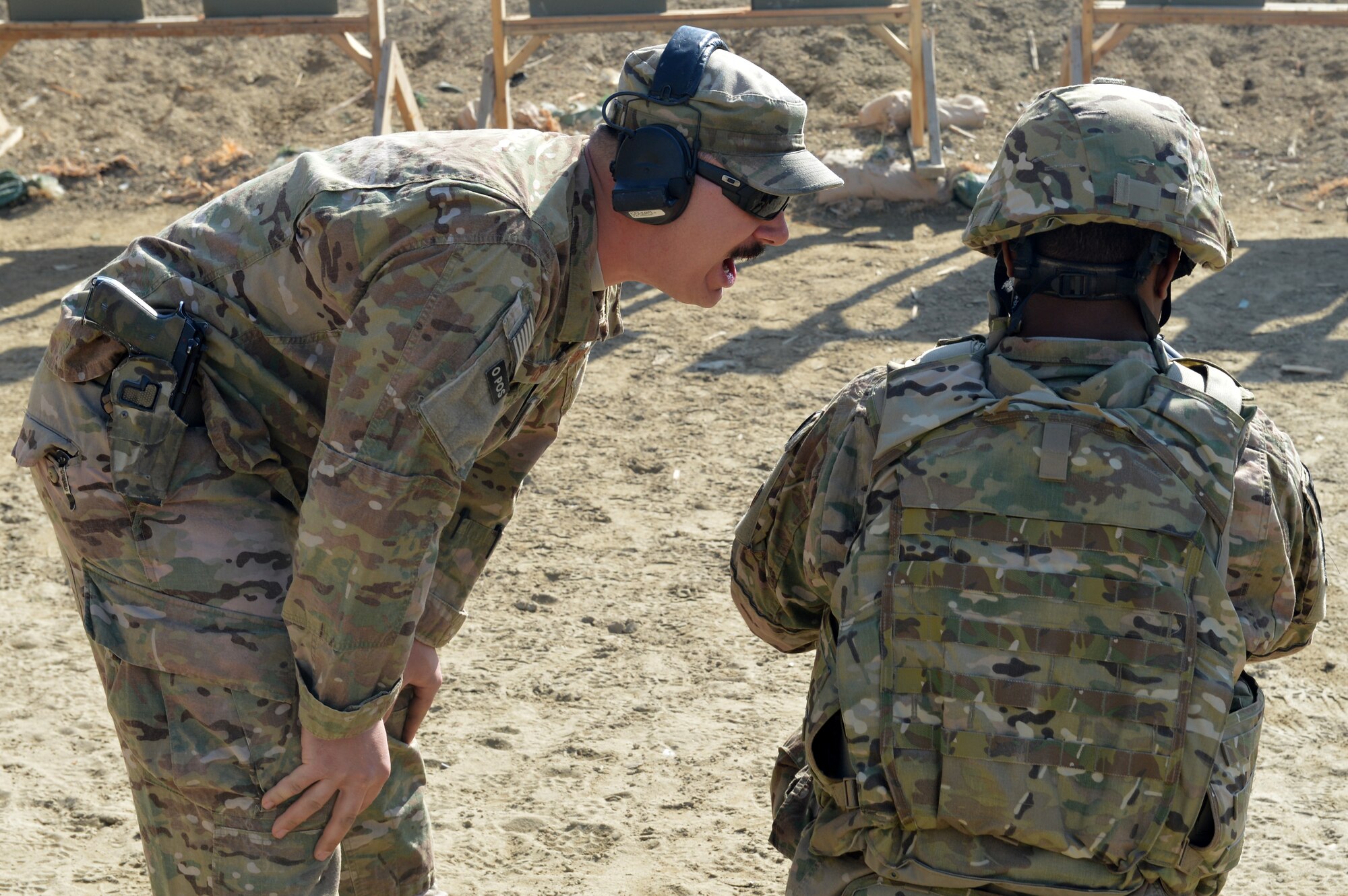 Tech. Sgt. Steven Ely, 455th Expeditionary Security Forces Group Combat Arms Training and Maintenance instructor, shouts orders at an Airman during an “active shooter” scenario on Bagram Airfield, Afghanistan, March 5, 2013.  The CATM instructors introduce a high-stress scenario as a training tactic for the Airmen to increase on situational awareness and engaging an enemy.  (U.S. Air Force photo/Senior Airman Chris Willis)