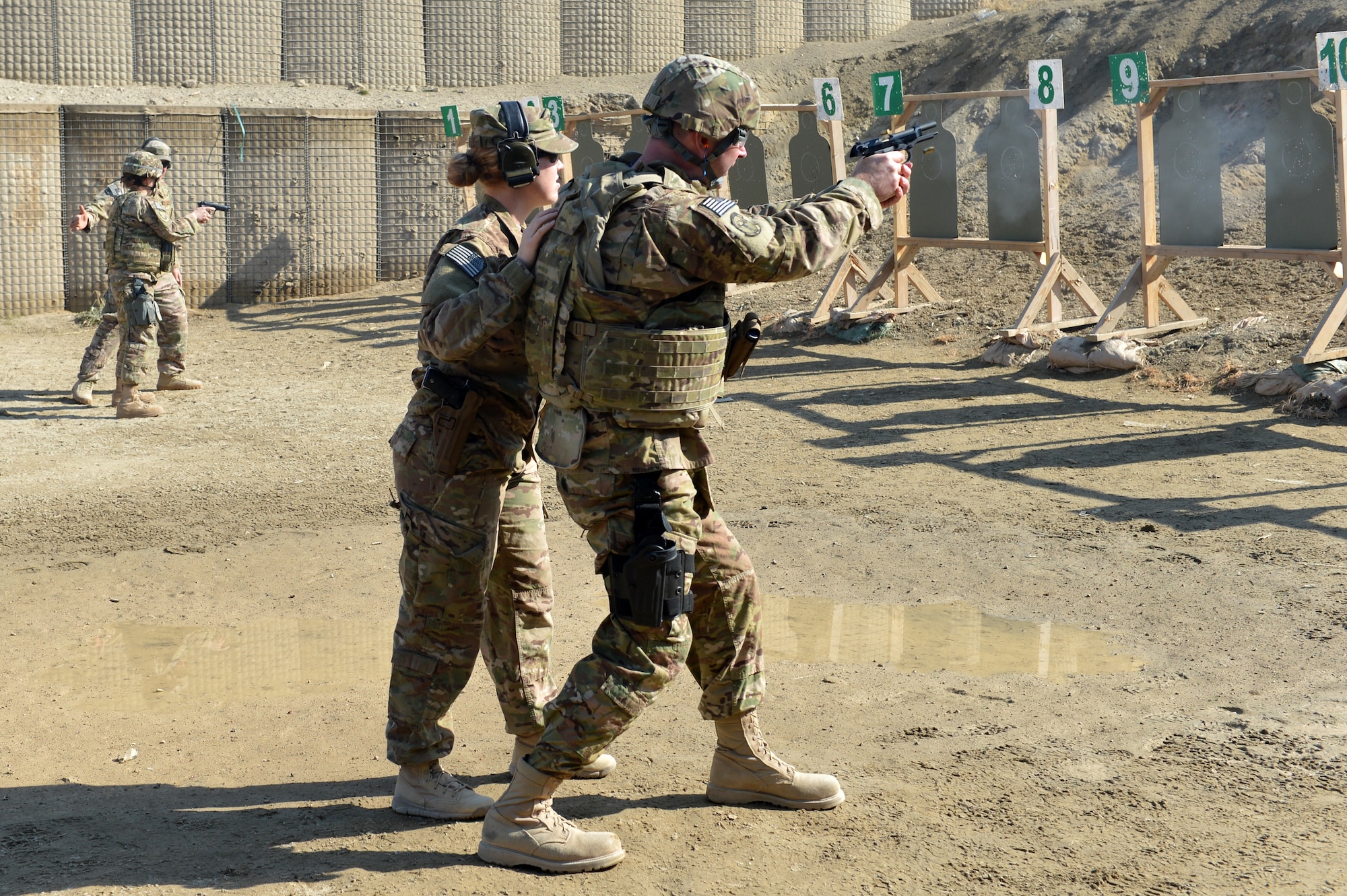 Instructors from the 455th Expeditionary Security Forces Group Combat Arms Training and Maintenance train Airmen on an “active shooter” scenario on Bagram Airfield, Afghanistan, March 5, 2013.  During the course Airmen are told to fire starting from a seated position and also while moving towards the target.  (U.S. Air Force photo/Senior Airman Chris Willis)