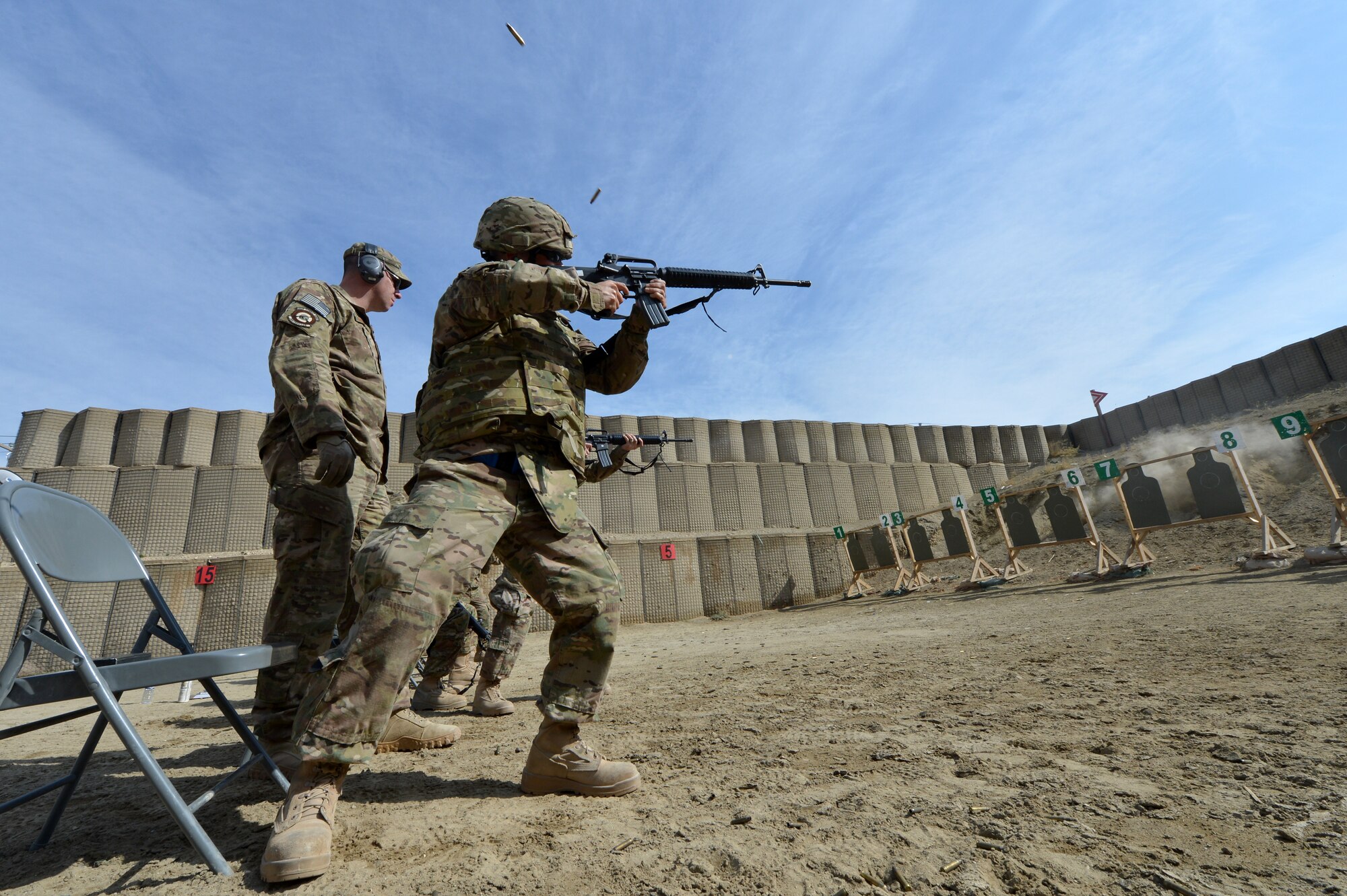 Instructors from the 455th Expeditionary Security Forces Group Combat Arms Training and Maintenance train Airmen on an “active shooter” scenario on Bagram Airfield, Afghanistan, March 7, 2013.  During the course Airmen are told to fire starting from a seated position and also while moving towards the target.  (U.S. Air Force photo/Senior Airman Chris Willis)