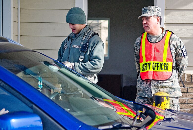 Master Sgt. Arthur Gauani, 436th Airlift Wing ground safety NCO in charge, and Airman Kody Crosson, 436th Security Forces Squadron, perform a seatbelt check March 15, 2013, at the base housing gate on Dover Air Force Base, Del. The safety office performed more than 600 seatbelt checks as they were doing their quarterly seatbelt check to educate Team Dover on safety awareness. (U.S. Air Force photo/Airman 1st Class Ashlin Federick) 