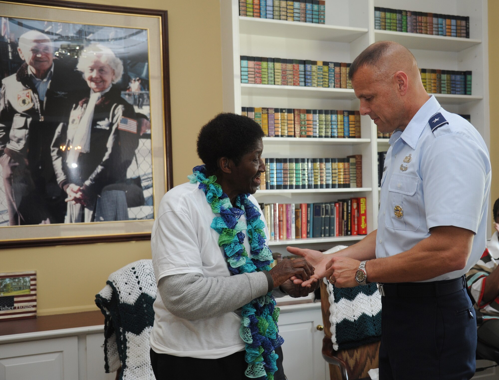 Mary Burley, housekeeper at Keesler Fisher House, receives a coin from Brig. Gen. Brad Spacy, 81st Training Wing commander, March 18, 2013, at Keesler Air Force Base, Miss.  The 72-year-old retires on March 29 with 45 years of service.  She spent 36 years at base lodging facilities and nine years as "lady of the house" at Fisher House.  (U.S. Air Force photo by Kemberly Groue)