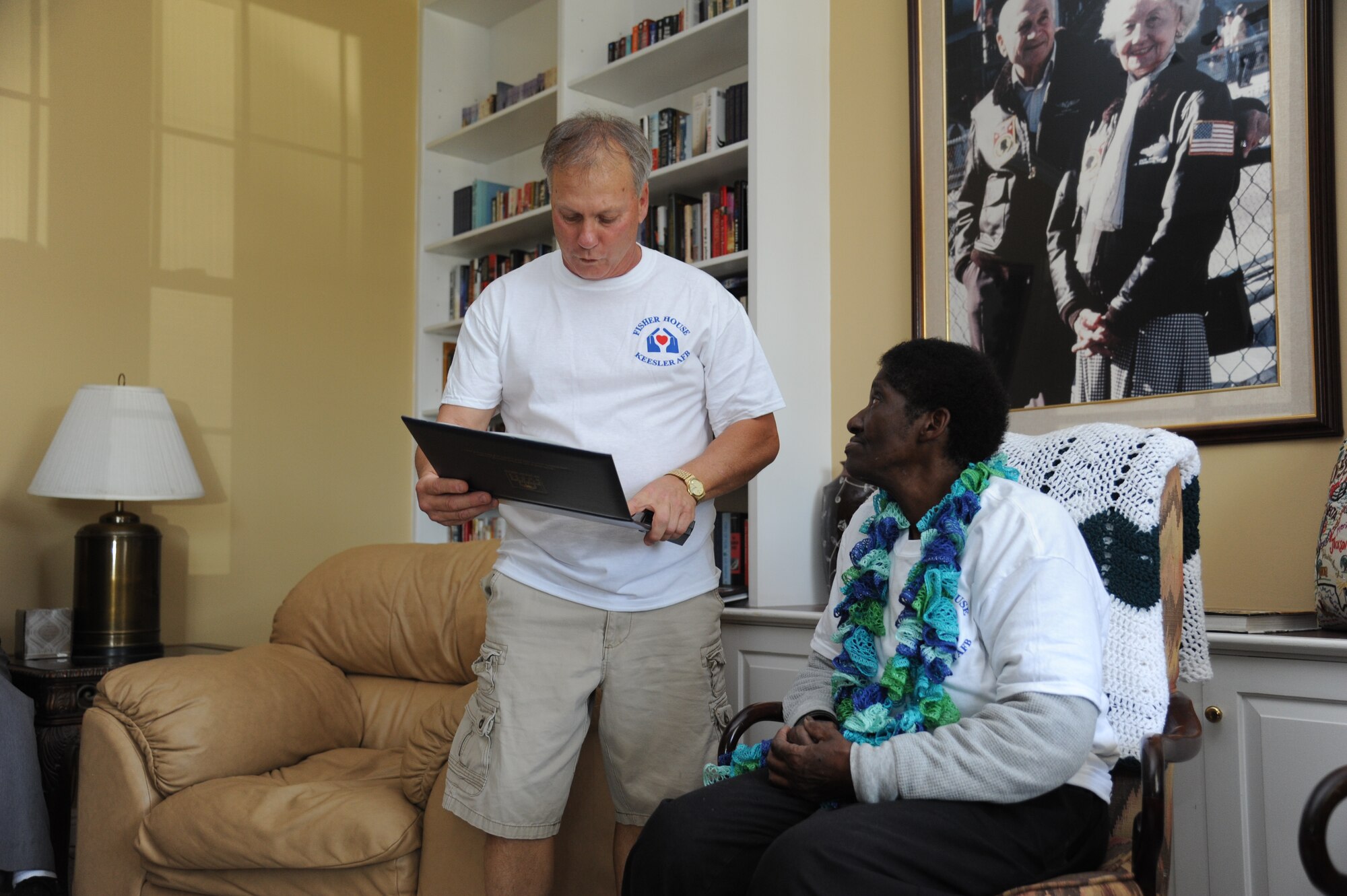 Larry Vetter, 81st Medical Group Fisher House director, presents a letter of appreciation from The Fisher House Foundation to Mary Burley, housekeeper at Keesler Fisher House,  March 18, 2013, at Keesler Air Force Base, Miss.  The 72-year-old retires on March 29 with 45 years of service.  She spent 36 years at base lodging facilities and nine years as "lady of the house" at Fisher House.  (U.S. Air Force photo by Kemberly Groue)