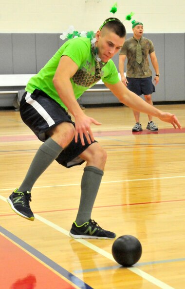 Alexander King, Honor Guard Team 1 player, reaches for a ball during the St. Patrick’s Day Dodgeball Tournament March 15, 2013, at the fitness center on Dover Air Force Base, Del. Honor Guard Team 1 won the championship defeating Honor Guard Team 2, 3-2. (U.S. Air Force photo/Tech. Sgt. Chuck Walker)