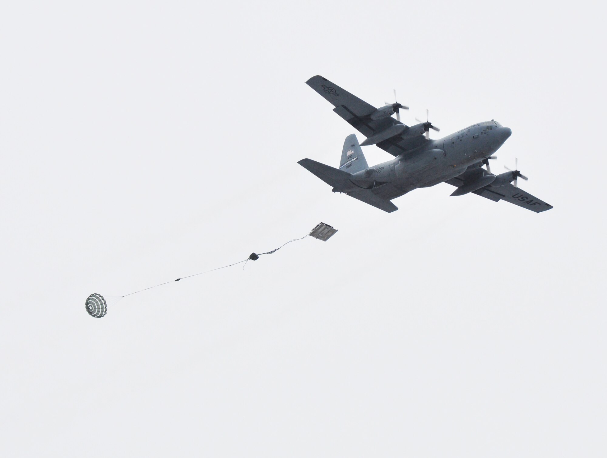 A C-130 Hercules aircraft from the 914th Airlift Wing drops heavy equipment loads during a training exercise March 2, 2013 at the Niagara Falls Air Reserve Station, N.Y.  (U.S. Air Force photo by Staff Sgt. Stephanie Clark)