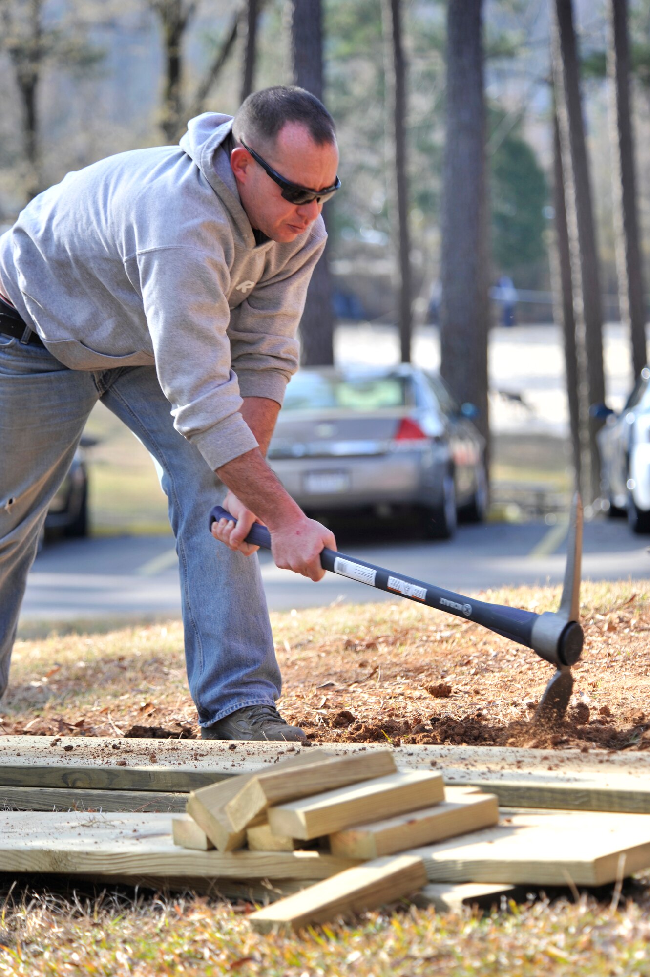 Kyle Ranville, 20th Force Support Squadron recreation assistant, digs a trench for the wood sides of a vegetable and herb garden, at the Wateree Recreation Area, Camden, S.C., March 16, 2013. The Wateree Recreation Area will now feature a community vegetable and herb garden. The community garden will be a seasonal effort for visitors to tend to and enjoy. (U.S. Air Force photo by Senior Airman Amber E. N. Jacobs/Released)