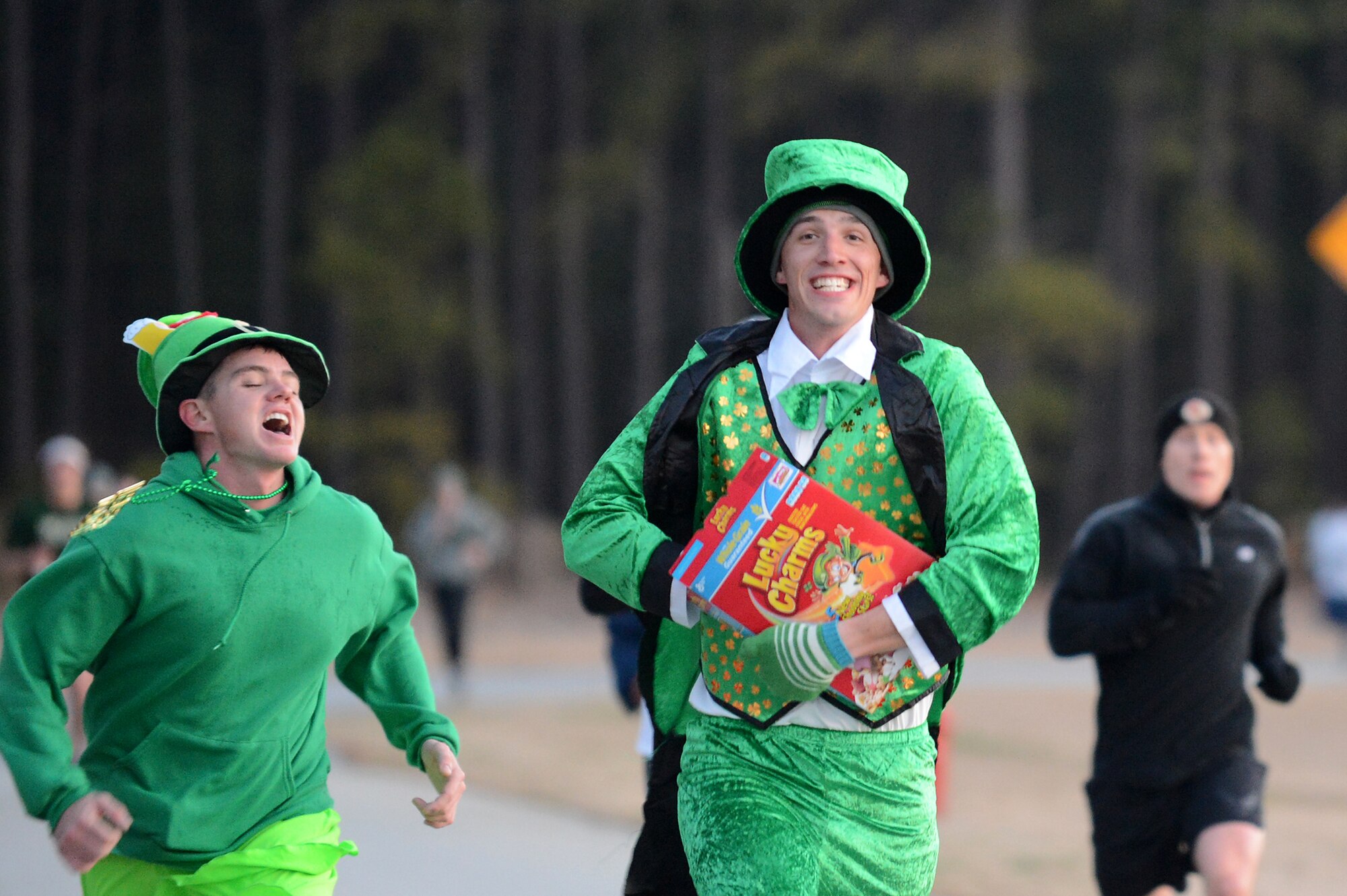 Airmen assigned to the 20th Civil Engineer Squadron, both explosive ordinance technicians, cross the finish line during the St. Patrick's Day 5km run at Shaw Air Force Base, S.C., March 15, 2013.  The 20th Force Support Squadron holds the annual 3-mile run, where service members are encouraged to show their spirit and wear green in celebration of the Irish holiday. More than 250 people attended the race.  (U.S. Air Force photo by Airman 1st Class Nicole Sikorski/Released)