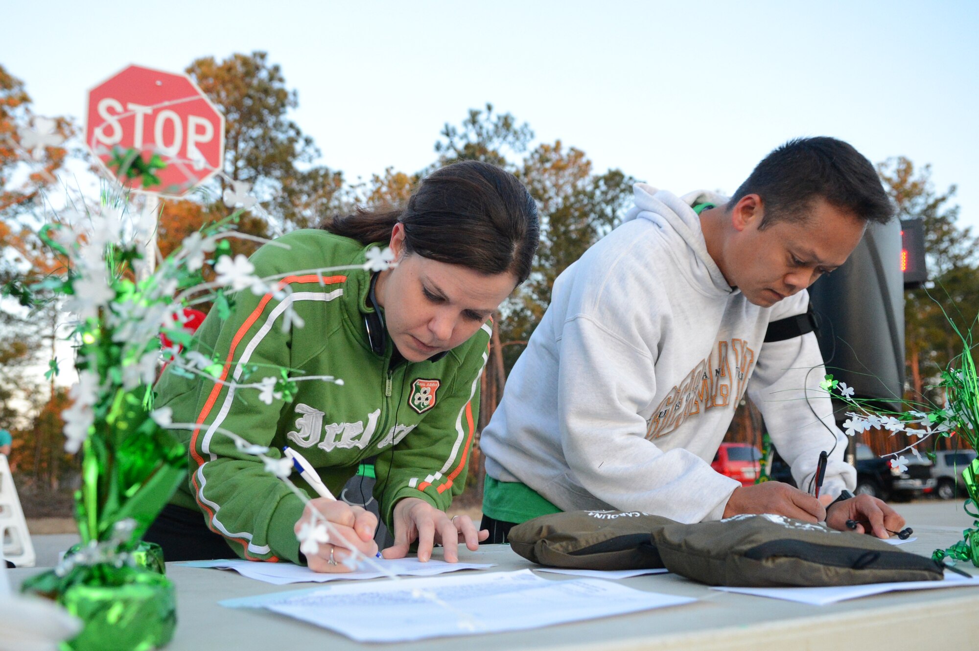 Airmen and Soldiers sign in at the Saint Patrick's Day 5km run at Shaw Air Force Base, S.C., March 15, 2013.  The 20th Force Support Squadron holds the annual 3-mile run, where service members are encouraged to show their spirit and wear green in celebration of the Irish holiday. More than 250 people attended the race.  (U.S. Air Force photo by Airman 1st Class Nicole Sikorski/Released)