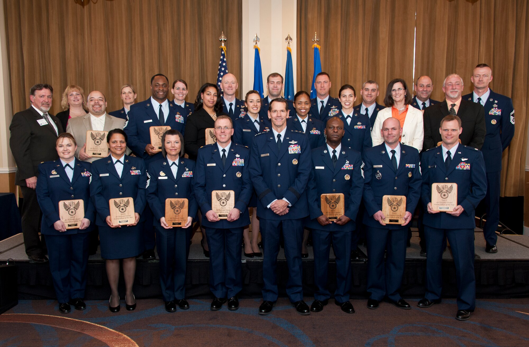Lt. Gen. Stanley E. Clarke III, director of the Air National Guard, and Mr. Gavin Macaloon, president of the D.W. Steele Sr. Memorial Chapter of the Air Force Association, recognizes the 2012 AFA ANG Action Officers of the Year during a ceremony at the Sheraton National Harbor Hotel, Arlington, Va. March 13, 2013. The AFA is a non-profit, independent, professional military and aerospace education association which promotes a dominant Air Force and strong national defense and honors Airmen and Air Force heritage. (National Guard photo by Master Sgt. Marvin R. Preston/RELEASED)