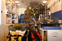 Tech. Sgt. Derrick Sims, 8th Medical Group, secures simulated burn victims in the ambulance during exercise Beverly Midnight 13-2 at Kunsan Air Base, Republic of Korea, Mar. 18, 2013. The scenario tested the unit’s ability to respond to and treat burn victims during a simulated fire. (U.S. Air Force photo by Senior Airman Marcus Morris/Released)