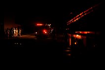 Firefighters with the 8th Civil Engineer Squadron prepare their equipment while responding to a fire at Kunsan Air Base, Republic of Korea, March 18, 2013. This was part of exercise Beverly Midnight 13-2 which tested the unit’s ability to respond to various scenarios. (U.S. Air Force photo by Senior Airman Marcus Morris/Released)
