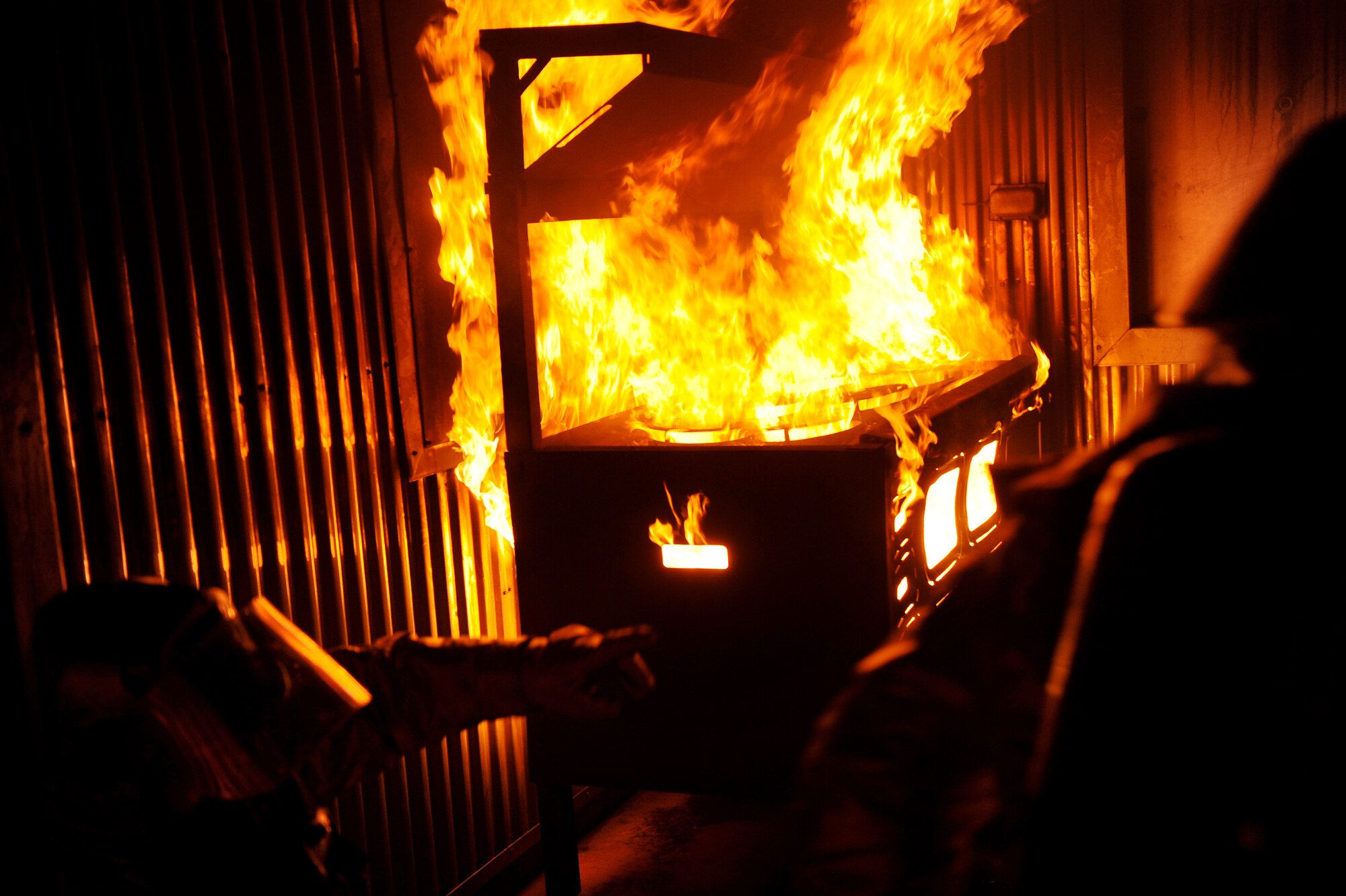 Tech. Sgt. Christopher Emerson, left, and Airman 1st Class Jayden Steier, 8th Civil Engineer Squadron firefighters, search for trapped Airmen in a simulated building fire during exercise Beverly Midnight 13-2 at Kunsan Air Base, Republic of Korea, March 18, 2013. The scenario tested their ability to put out fires and rescue victims. (U.S. Air Force photo by Senior Airman Marcus Morris/Released)