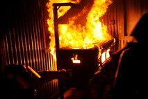 Tech. Sgt. Christopher Emerson, left, and Airman 1st Class Jayden Steier, 8th Civil Engineer Squadron firefighters, search for trapped Airmen in a simulated building fire during exercise Beverly Midnight 13-2 at Kunsan Air Base, Republic of Korea, March 18, 2013. The scenario tested their ability to put out fires and rescue victims. (U.S. Air Force photo by Senior Airman Marcus Morris/Released)