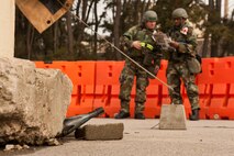 Staff Sgt. Brian Cummings, left,and Tech. Sgt. Emanuel Rodrigues, 8th Medical Support Squadron members, look up information on the unexploded ordnance Rodrigues found following a simulated attack at Kunsan Air Base, Republic of Korea, March 19, 2013. This was part of a training scenario designed to test the members’ ability to find, identify and report UXOs. (U.S. Air Force photo by Staff Sgt. Jonathan Fowler/Released)