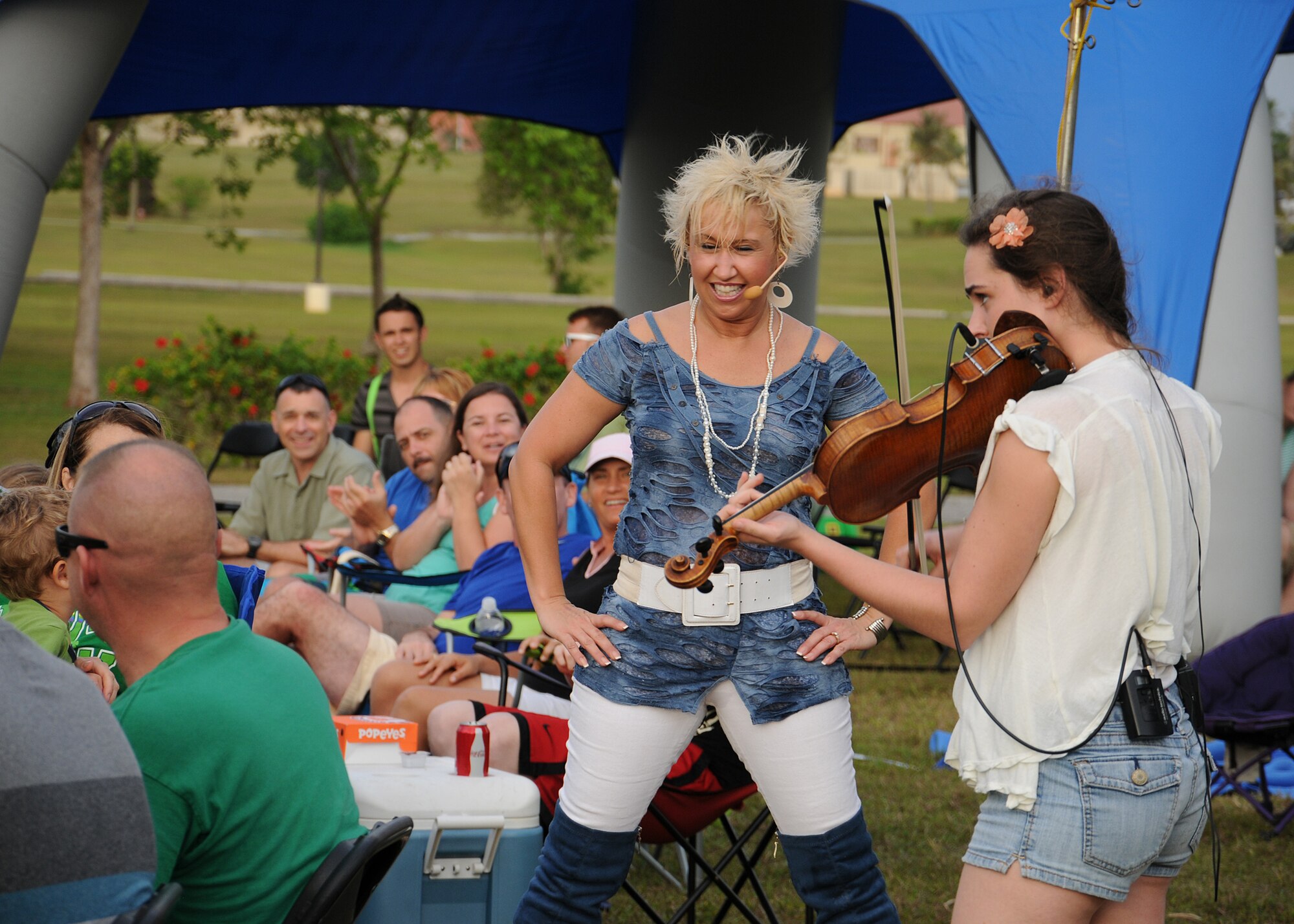 Mustang Sally members perform among the crowd on Andersen Air Force Base, Guam, March 17, 2013. The all-female country and western group visited the base and Naval Base Guam as part of an Armed Forces Entertainment tour which also took them to military installations in Hawaii.  (U.S. Air Force photo by Staff Sgt. Melissa B. White/Released)