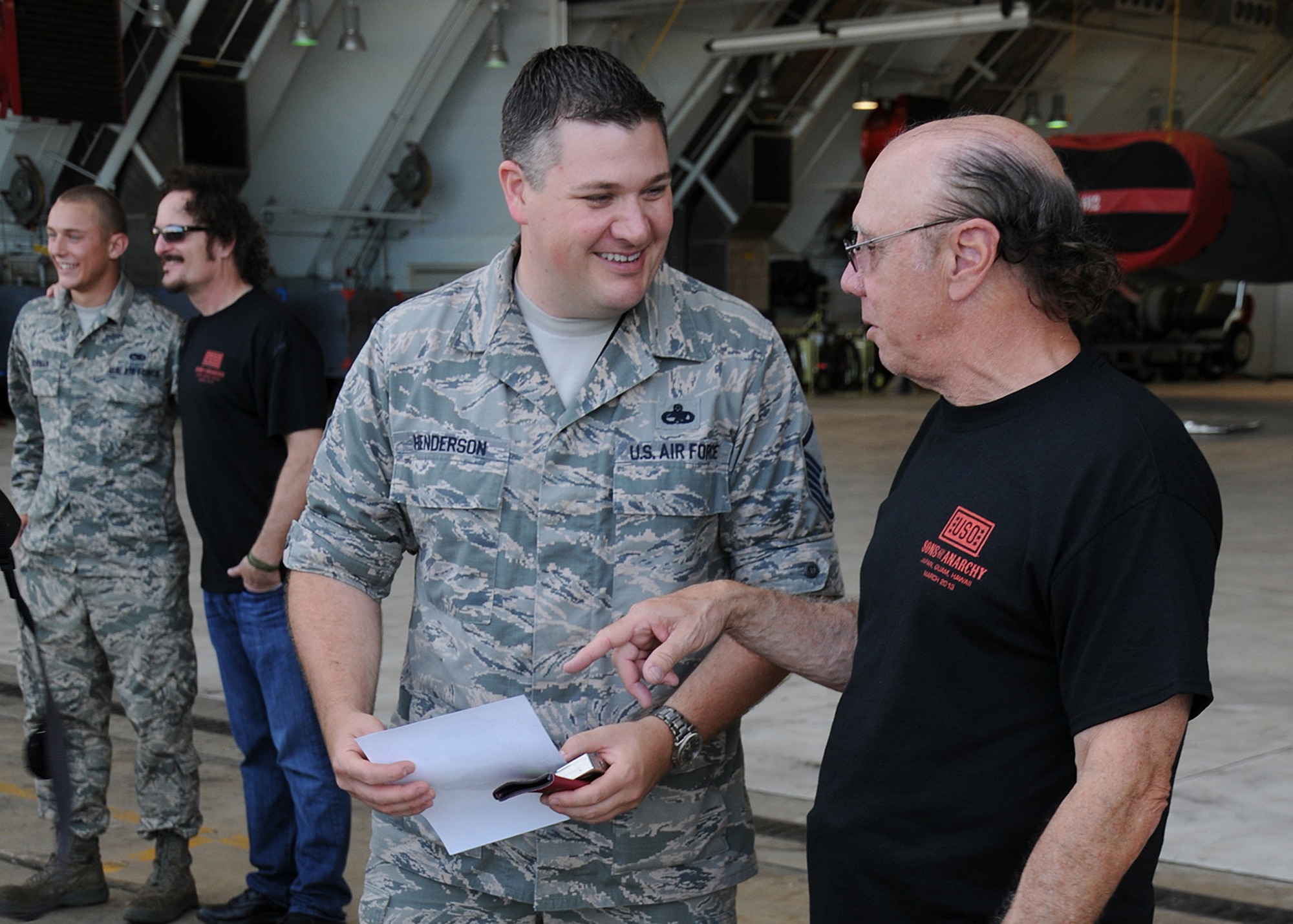 Dayton Callie, “Sons of Anarchy” actor, talks with Master Sgt. John Henderson, 36th Expeditionary Aircraft Maintenance Squadron Specialist Flight chief deployed here from the 96th Aircraft Maintenance Unit at Barksdale Air Force Base, La., at Hangar 1 on Andersen Air Force Base, Guam, March 16, 2013. The actors visited the base as part of a weeklong United Service Organization tour which also took them to military installations in Japan and Hawaii. (U.S. Air Force photo by Staff Sgt. Melissa B. White/Released)