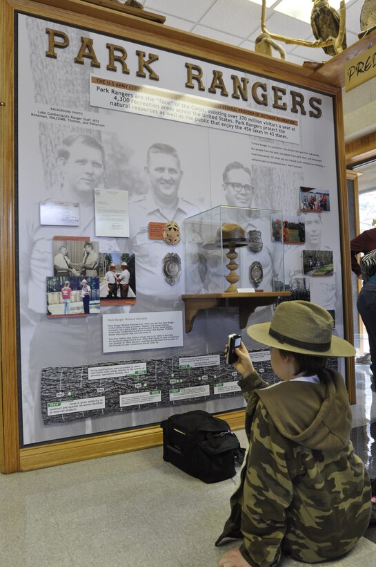 Jacob Halcomb, 11, the grandson of Park Ranger Wallace Halcomb, wears his grandfather’s original ranger hat and badge as he looks at an honorary display wall March 13, 2013 to commemorate the service of Park Ranger Wallace Halcomb and park rangers at the Lake Cumberland Visitor's Center. 