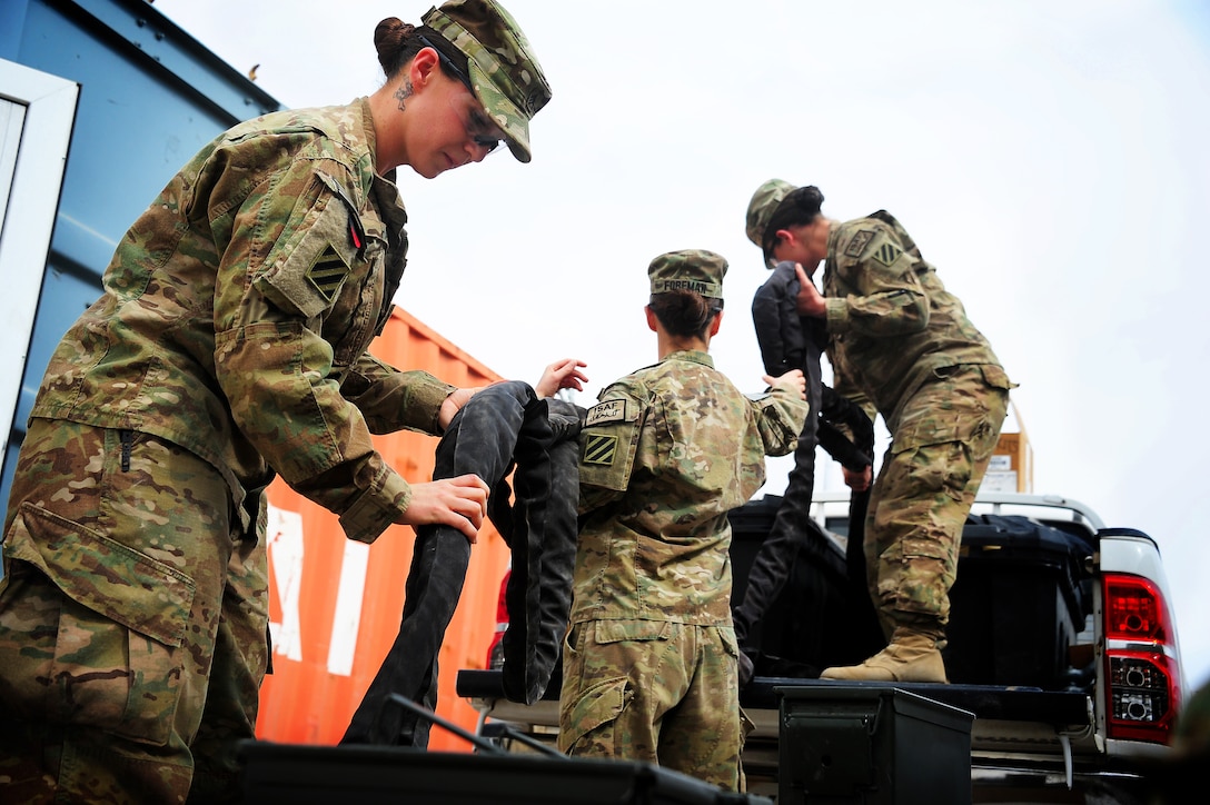 U.S. Army Sgt. Sydney Hays, Spc. Alexandria Foreman and Sgt. Selvija Bajrami unload equipment from a vehicle during an inventory at Multinational Base Tarin Kot, Afghanistan, March 18, 2013. The three women are stationed at Fort Stewart, Ga., and are assigned to Headquarters and Headquarters Company, 2nd Armored Brigade Combat Team, 3rd Infantry Division. 