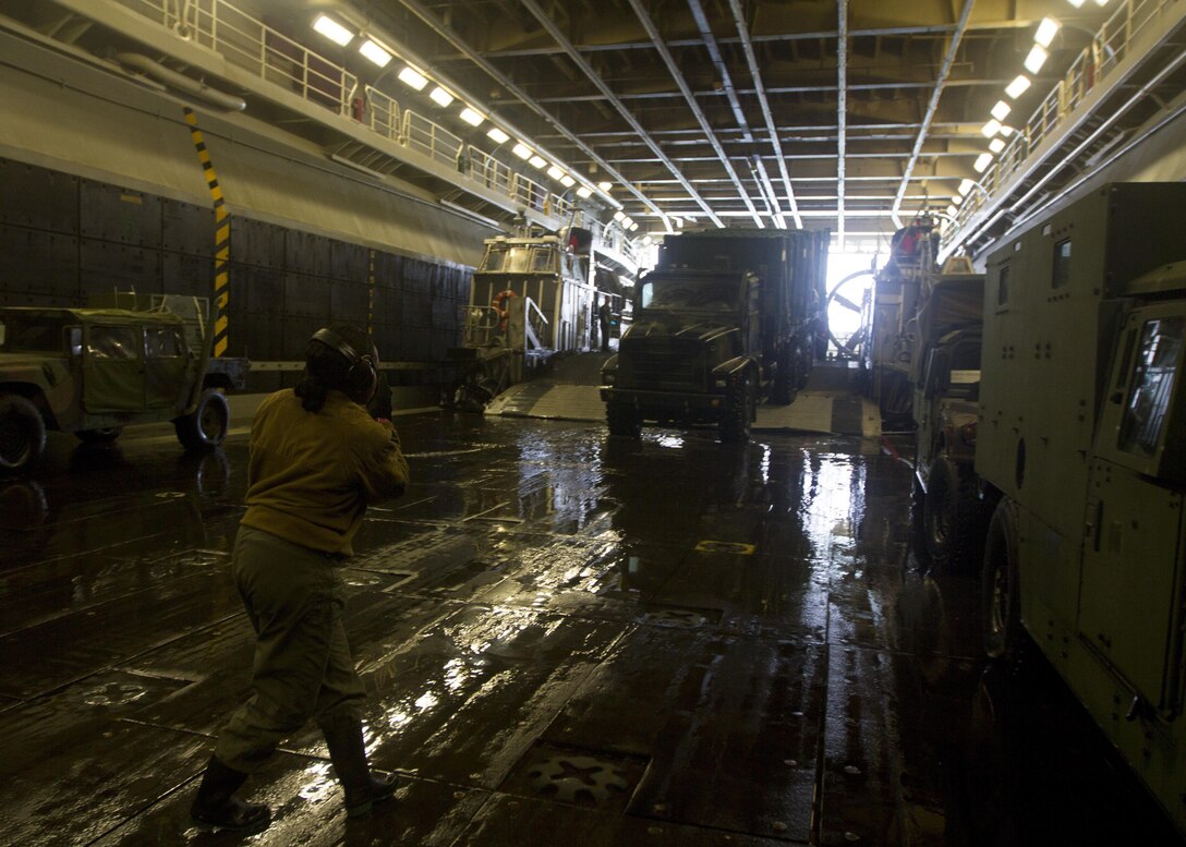 Marines assigned to the 26th Marine Expeditionary Unit (MEU) unload their gear and vehicles off of landing craft, air cushion vessels assigned to the USS Kearsarge (LHD 3), off the coast of Onslow Beach, N.C., March 13, 2013. The 26th MEU is deploying to the 5th Fleet and 6th Fleet areas of operation. The MEU operates continuously across the globe, providing the president and unified combatant commanders with a forward-deployed, sea-based, quick-reaction force. The MEU is a Marine Air-Ground Task Force capable of conducting amphibious operations, crisis-response and limited contingency operations. (U.S. Marine Corps photo by Cpl. Kyle N. Runnels/Released)