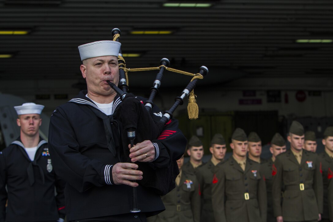 Marines assigned to the 26th Marine Expeditionary Unit and Sailors assigned to the USS Kearsarge (LHD 3) show their respects during a burial at sea ceremony while underway March 19, 2013. The 26th MEU is deploying to the 5th Fleet and 6th Fleet areas of operation. The MEU operates continuously across the globe, providing the president and unified combatant commanders with a forward-deployed, sea-based, quick-reaction force. The MEU is a Marine Air-Ground Task Force capable of conducting amphibious operations, crisis-response and limited contingency operations. (U.S. Marine Corps photo by Cpl. Kyle N. Runnels/Released)