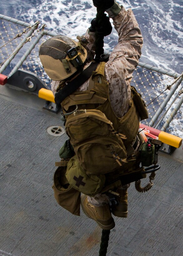Marines and Sailors assigned to the 26th Marine Expeditionary Unit (MEU) maritime raid force fast rope aboard the USS Kearsarge (LHD 3) while at sea March 19, 2013. The 26th MEU is deploying to the 5th Fleet and 6th Fleet areas of operation. The MEU operates continuously across the globe, providing the president and unified combatant commanders with a forward-deployed, sea-based, quick-reaction force. The MEU is a Marine Air-Ground Task Force capable of conducting amphibious operations, crisis-response and limited contingency operations. (U.S. Marine Corps photo by Cpl. Kyle N. Runnels/Released)