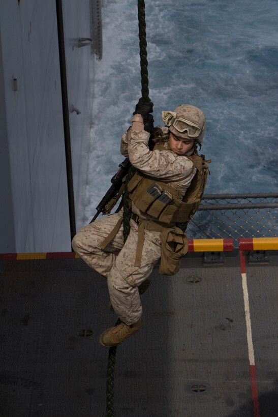 Marines and Sailors assigned to the 26th Marine Expeditionary Unit (MEU) maritime raid force fast rope aboard the USS Kearsarge (LHD 3) while at sea March 19, 2013. The 26th MEU is deploying to the 5th Fleet and 6th Fleet areas of operation. The MEU operates continuously across the globe, providing the president and unified combatant commanders with a forward-deployed, sea-based, quick-reaction force. The MEU is a Marine Air-Ground Task Force capable of conducting amphibious operations, crisis-response and limited contingency operations. (U.S. Marine Corps photo by Cpl. Kyle N. Runnels/Released)