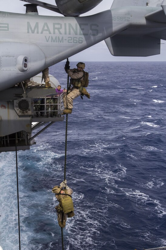 Marines and Sailors assigned to the 26th Marine Expeditionary Unit (MEU) maritime raid force fast rope aboard the USS Kearsarge (LHD 3) while at sea March 19, 2013. The 26th MEU is deploying to the 5th Fleet and 6th Fleet areas of operation. The MEU operates continuously across the globe, providing the president and unified combatant commanders with a forward-deployed, sea-based, quick-reaction force. The MEU is a Marine Air-Ground Task Force capable of conducting amphibious operations, crisis-response and limited contingency operations. (U.S. Marine Corps photo by Cpl. Kyle N. Runnels/Released)