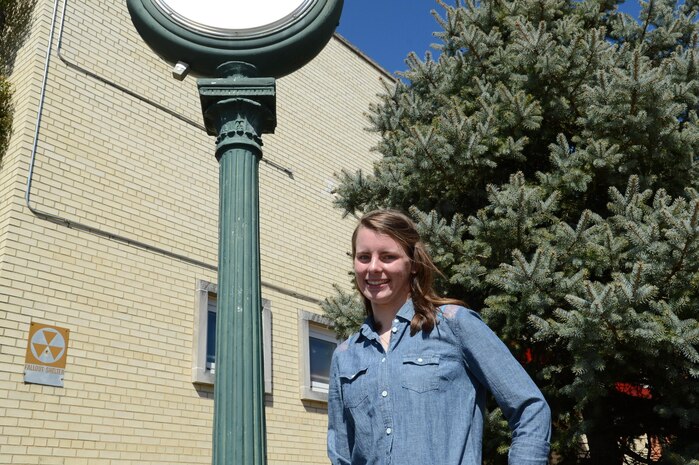 Kelsie, senior athlete, Quantico Middle/High School, stands by a clock outside of her school on March 19. Kelsie has been accepted to the United States Naval Academy in Annapolis, Md., for this coming fall.