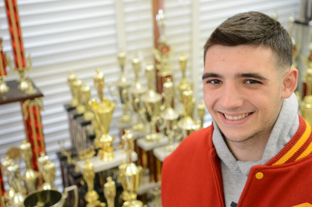 Trent, senior athlete, Quantico Middle/High School, smiles confidently beside athletic trophies at the school on March 19. Trent has been accepted to the United States Naval Academy in Annapolis, Md., for this coming fall. He said he would like to become an infantry officer or fly an aircraft after the academy.