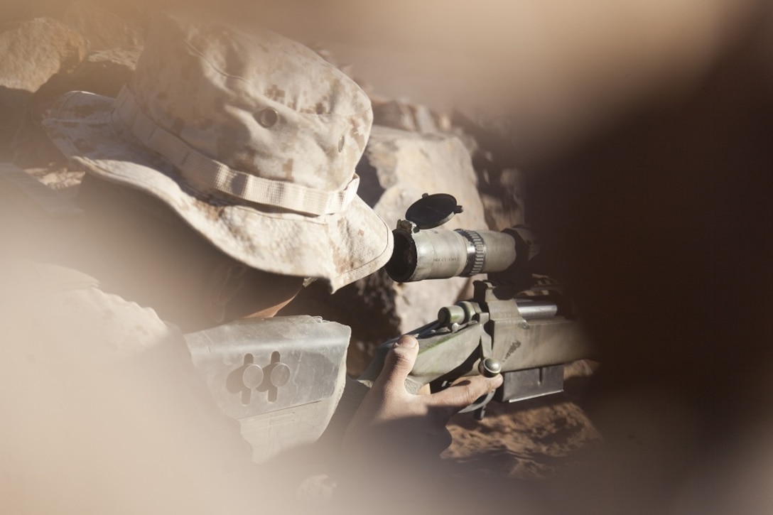 U.S. Marine Corps Sgt. Emmanuel Velayo, chief scout with scout sniper team 1, scout sniper platoon, 1st Battalion, 4th Marines, 1st Marine Regiment, fires his M40A5 Sniper Rifle during range 401 on Marine Corps Air Ground Combat Center Twentynine Palms, Calif., Dec. 4, 2012. Range 401 is a company maneuver and fire exercise held as part of Exercise Steel Knight. Exercise Steel Knight is an annual training exercise held to demonstrate the 1st Marine Division's abilities in a simulated combat scenario. (U.S. Marine Corps photo by Cpl. Jonathan R. Waldman/Released)