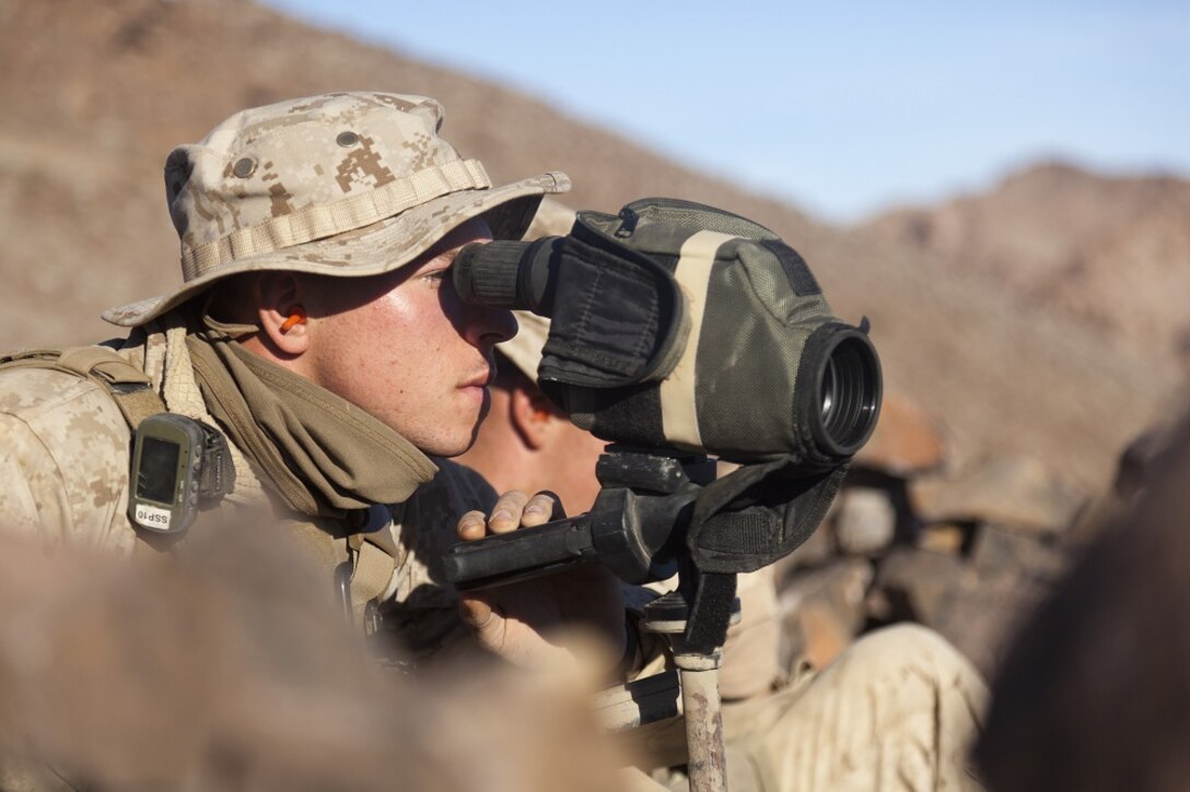 U.S. Marine Corps Pfc. Ben Downing, assistant radio operator with scout sniper team 1, scout sniper platoon, 1st Battalion, 4th Marines , 5th Marine Regiment, uses a spotting scope to determine shot distances during range 401 on Marine Corps Air Ground Combat Center Twentynine Palms, Calif., Dec. 4, 2012. Range 401 is a company maneuver and fire exercise held as part of Exercise Steel Knight. Exercise Steel Knight is an annual training exercise held to demonstrate the 1st Marine Division's abilities in a simulated combat scenario. (U.S. Marine Corps photo by Cpl. Jonathan R. Waldman/Released)